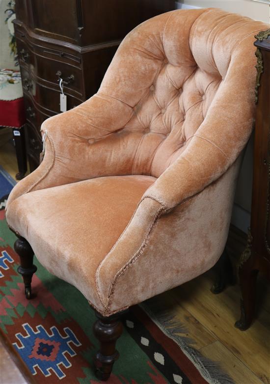 A Victorian buttoned easy chair, on turned tapered legs with brass caps and castors
